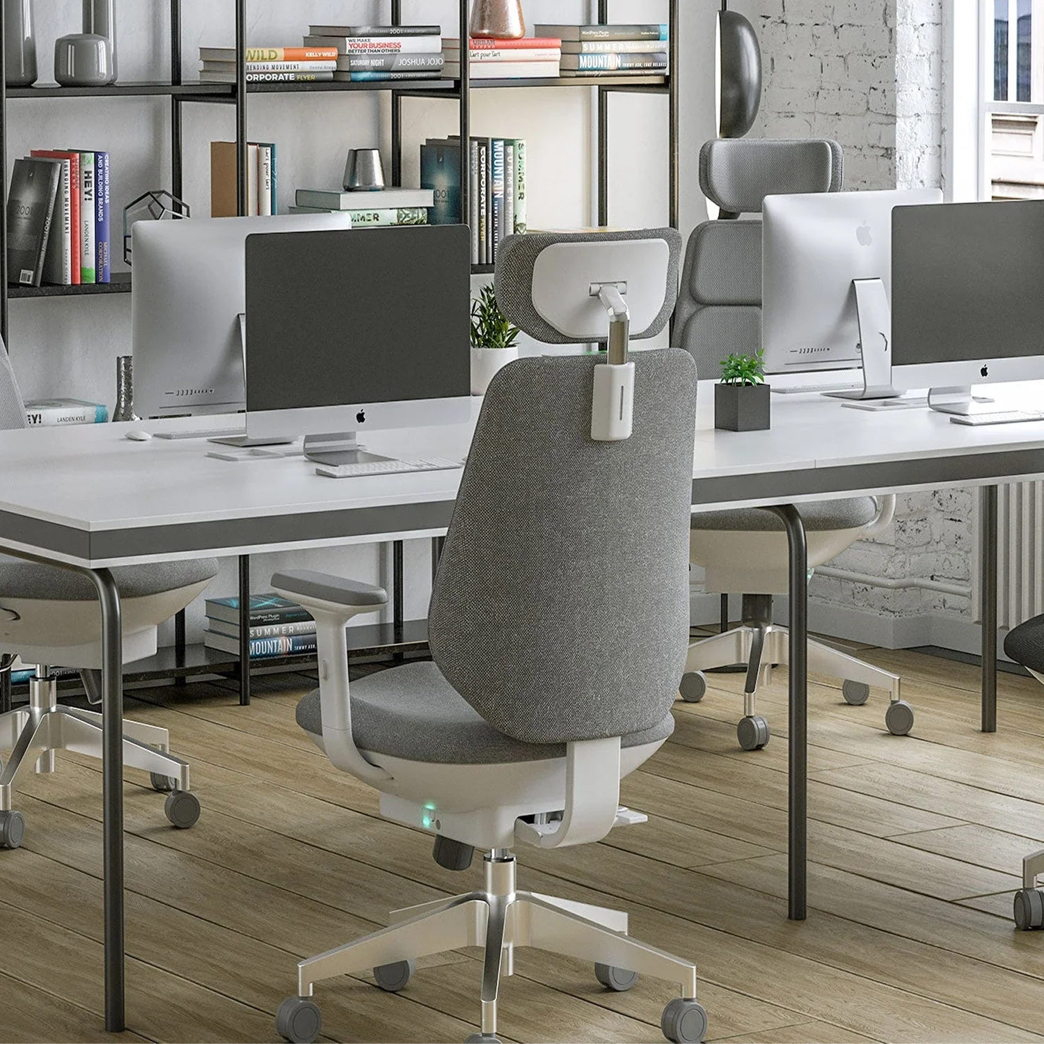 [scene] Air-Smart chair in modern open office workspace with multiple workstations.